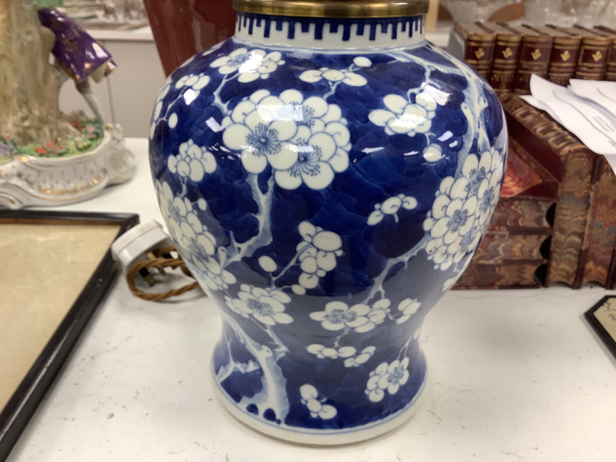 A large Chinese sang de boeuf lamp base and a similar blue and white prunus lamp base, both Qing dynasty, 41 and 21 cm high excluding fittings